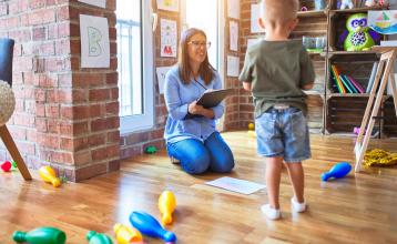A therapist doing an assessment with a young boy.