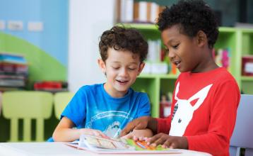 two boys reading together in a child care setting