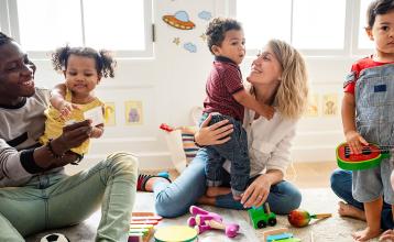 Parents and their children play on the floor