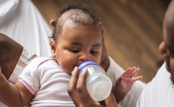 Father feeding his baby a bottle