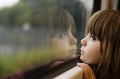 sad girl looking out of window