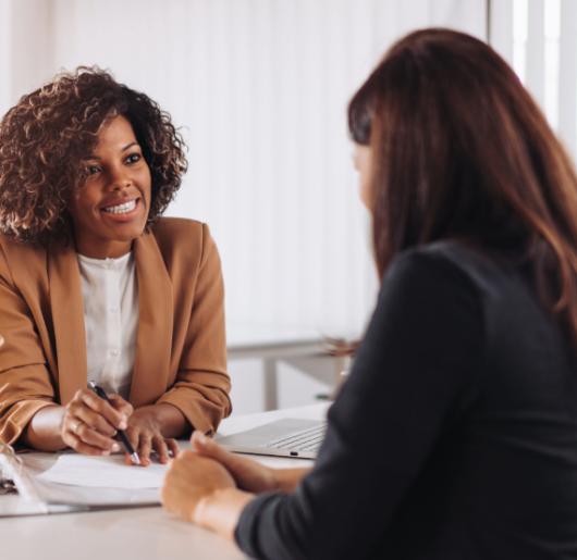 Woman consulting with a female manager at a bank.