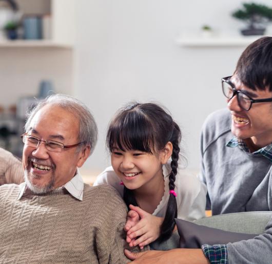 A happy multigenerational family sitting on the couch.