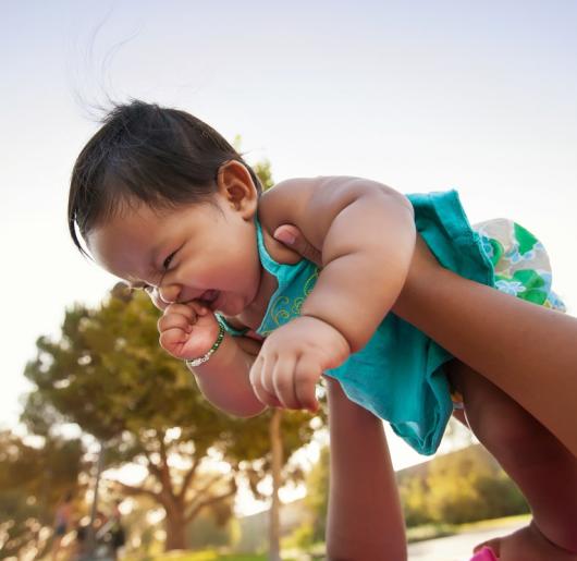 Baby girl held up in the air 