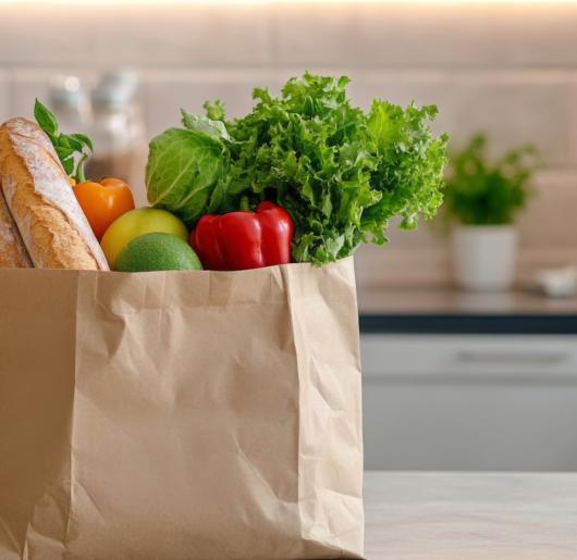 Bag of food from the grocery store on an island in a kitchen. 