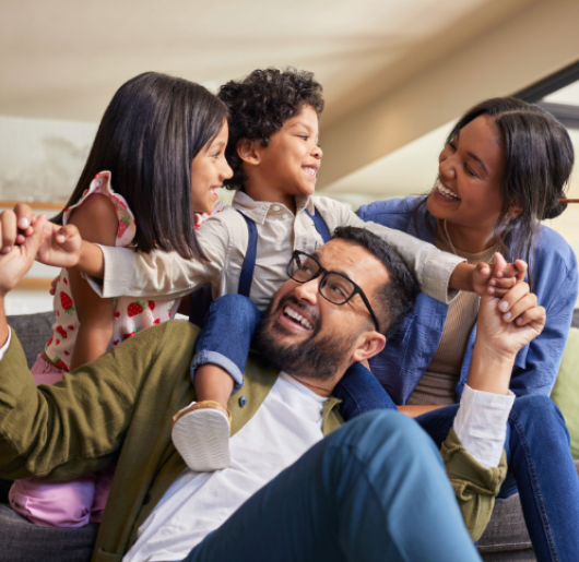 Family playing and embracing in a living room