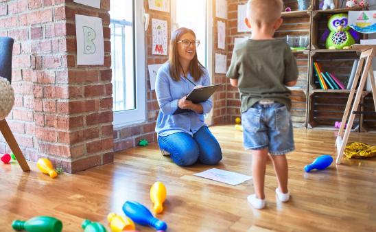 A therapist doing an assessment with a young boy. 