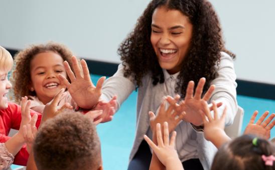 Teacher and students high fiving