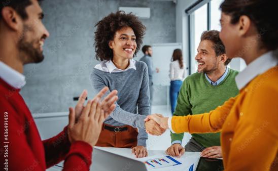 four people standing and talking