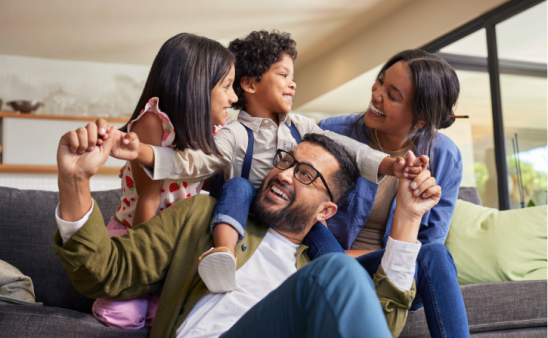 Family playing and embracing in a living room
