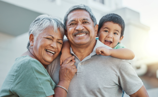 Grandparents smiling with a child