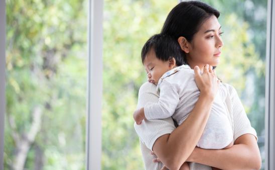 Mom holds a sleeping baby