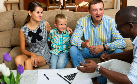 Social worker showing a computer to a family