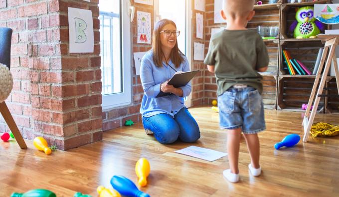 A therapist doing an assessment with a young boy. 