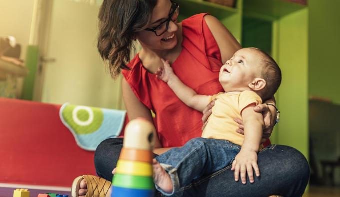 Child care educators with a young infant. 