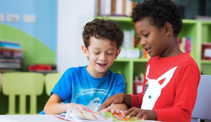 two boys reading together in a child care setting