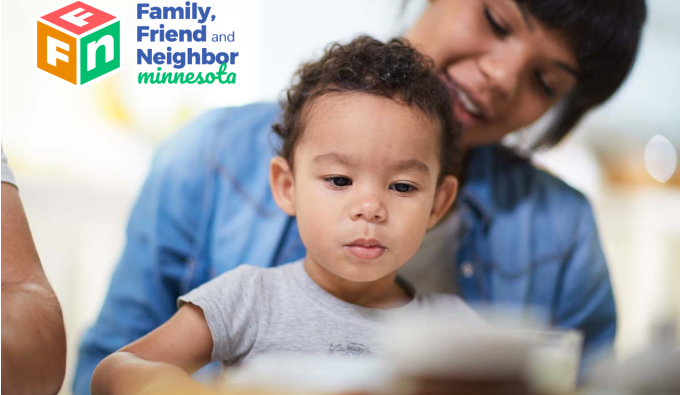 Child care provider with young child on her lap looking at a book