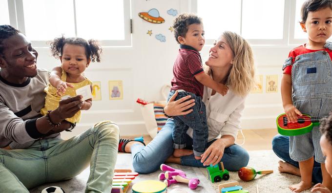 Parents and their children play on the floor