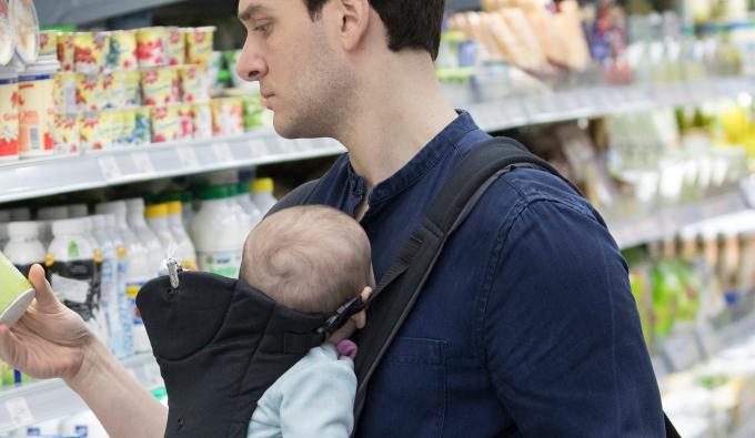 Man and baby in grocery store.