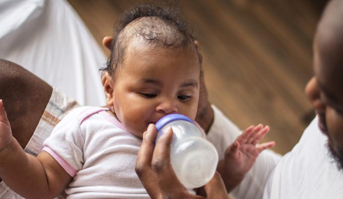 Father feeding his baby a bottle