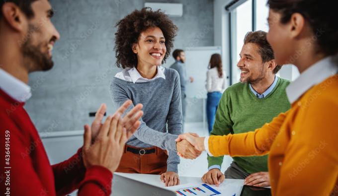 four people standing and talking