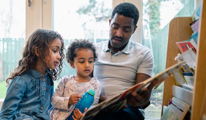 A dad reads to his two young children