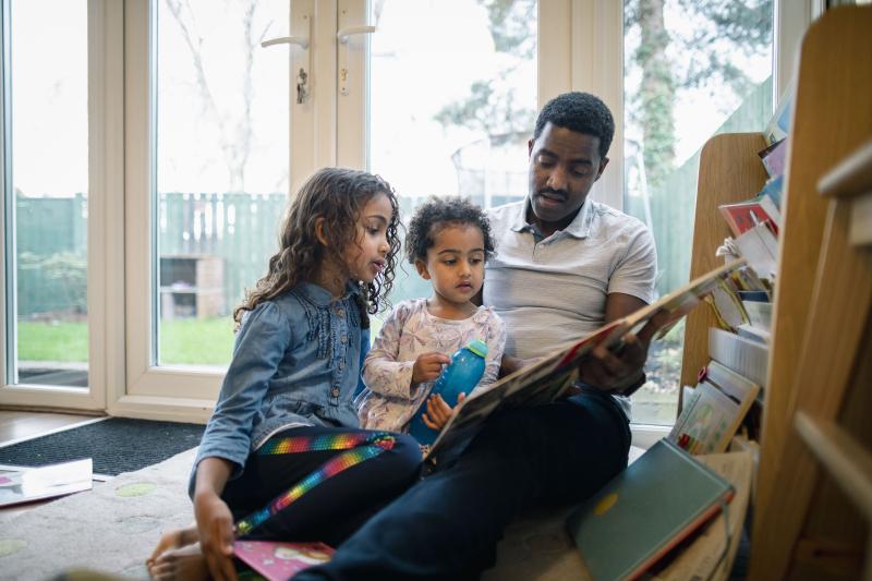Dad reads to two young daughters