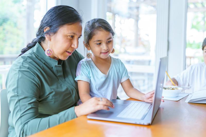 Mom and daughter looking at a laptop