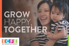 Postcard with a caregiver and toddler with text "Grow Happy, Together"
