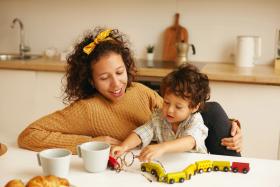 Mom and toddler playing with trains