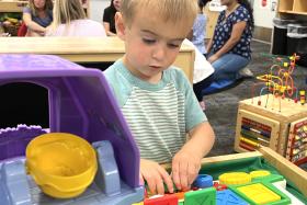 Toddler playing with a pop-up toy