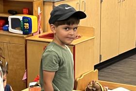 Preschooler wearing a baseball hat