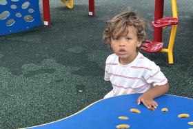 Boy sits at a table at the playground