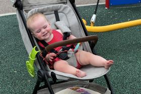 Smiling baby in a stroller