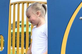 Girl on playground equipment