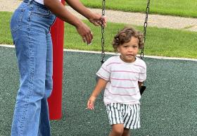 Boy gets on the swing