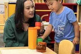 Toddler and mom with a toy coffee set and cups
