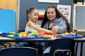 Preschool girl and her mom playing with toys