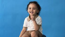 Child laughing while posing for a photo