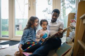 Dad reads to two young daughters