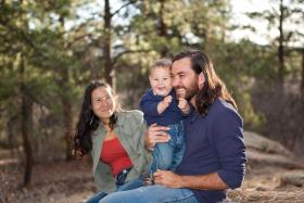 Mom, dad and child walking in the woods